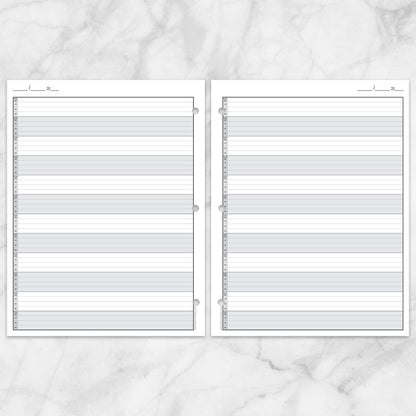 The printable front and back pages of the Full-Width Schedule Sheet in 15-Minute Increments shown as facing pages with 3 holes punched, on a marble surface.