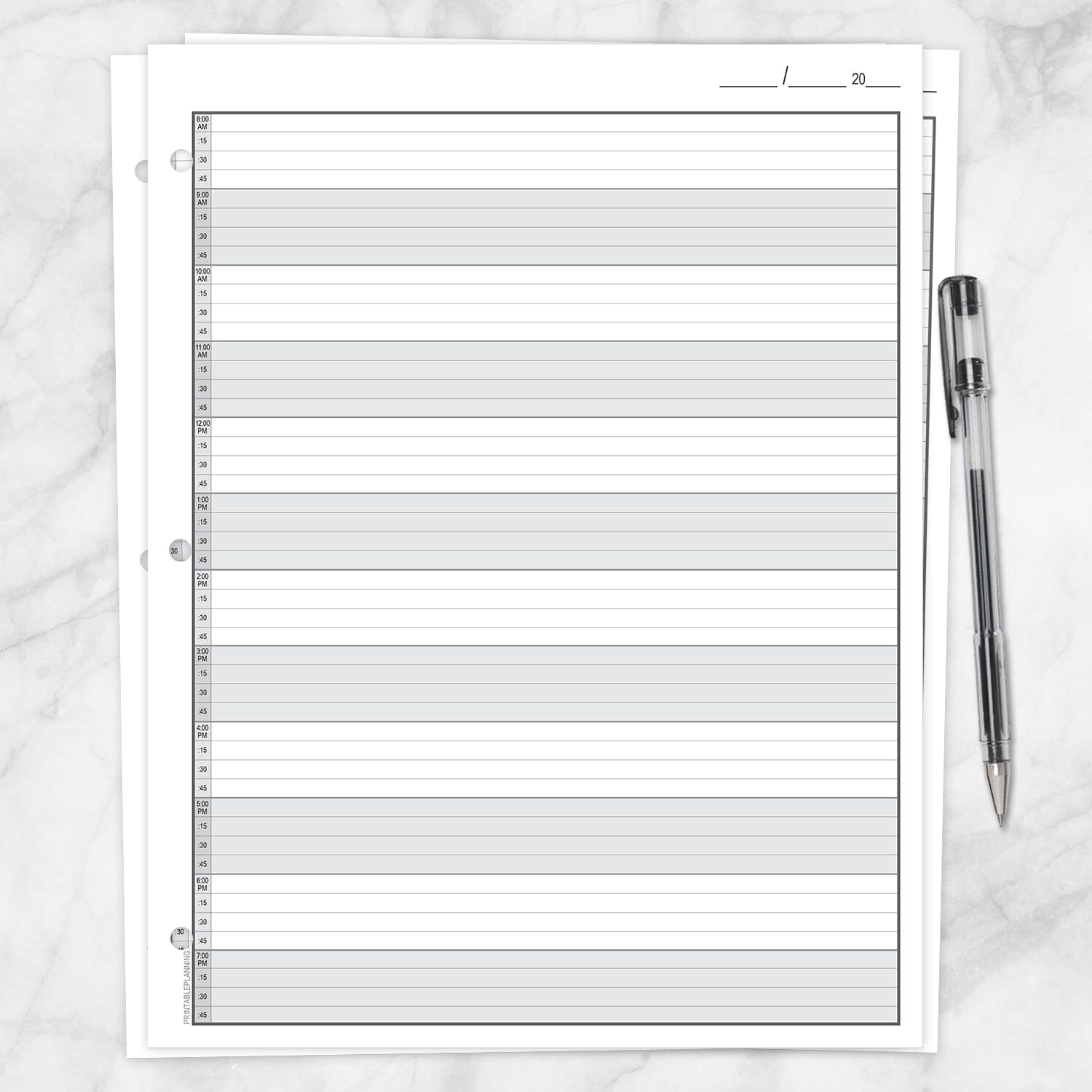 The printable front page of the Full-Width Schedule Sheet in 15-Minute Increments on a marble surface with a pen.