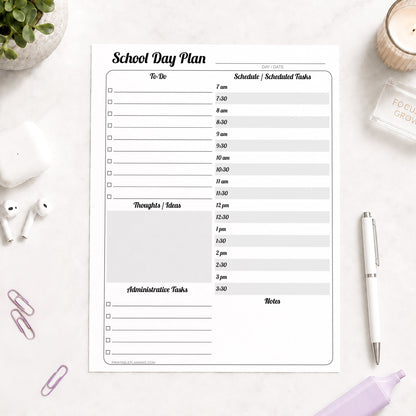 A printed School Staff Daily Planner with Schedule and To-Do List (printable page) shown on a desk with a plant, earbuds, paperclips, highlighter, and a pen.