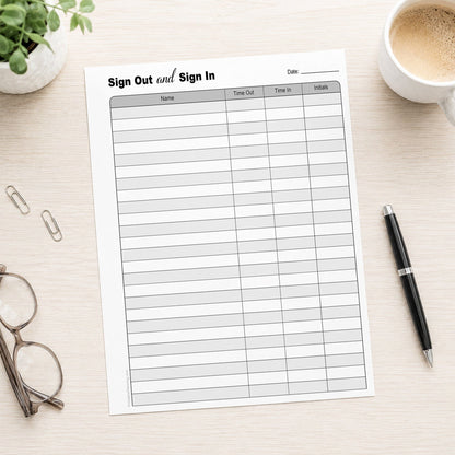 The printed Sign Out and Sign In Sheet (printable page) shown on a table with a plant, glasses, paperclips, coffee, and a pen.