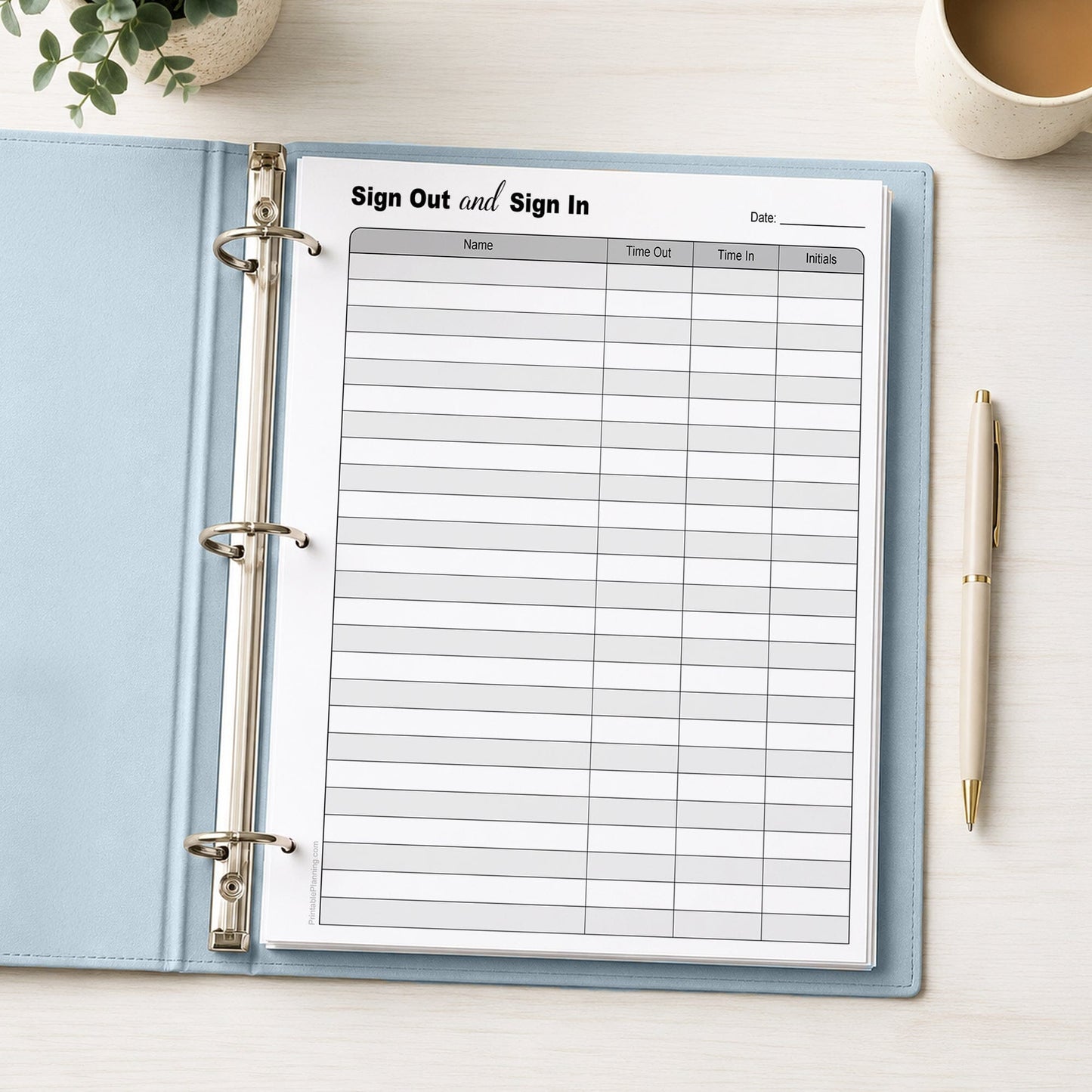 The printed Sign Out and Sign In Sheet (printable page) shown in a light blue binder on a desk with a plant, coffee, and a pen.