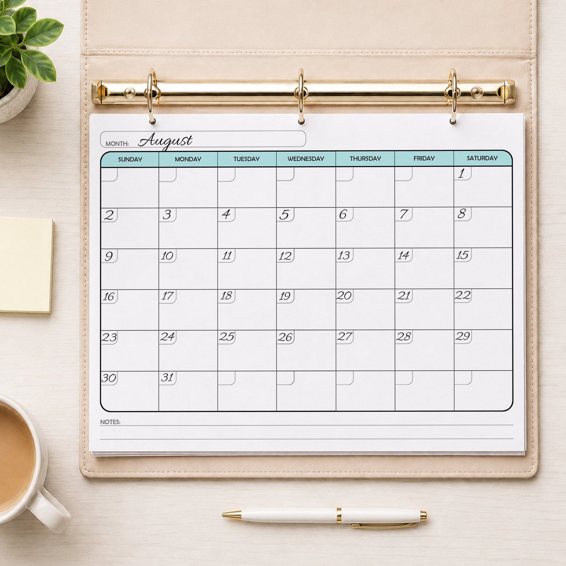 A printed Undated Monthly Calendar - Teal Full-Page Planner (printable) page shown with example writing in a beige binder on a desk with a plant, sticky notes, coffee, and a pen.