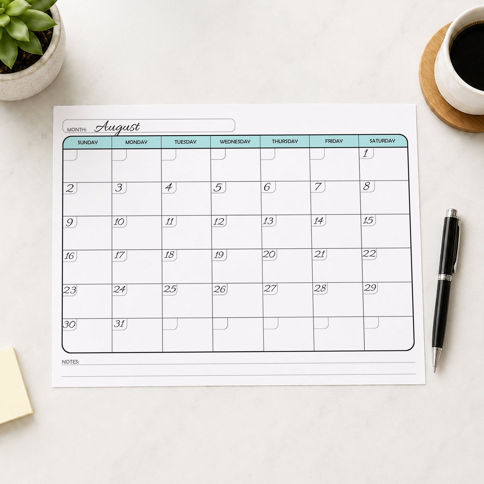 A printed Undated Monthly Calendar - Teal Full-Page Planner (printable) page shown with example writing on a desk with a plant, sticky notes, coffee, and a pen.