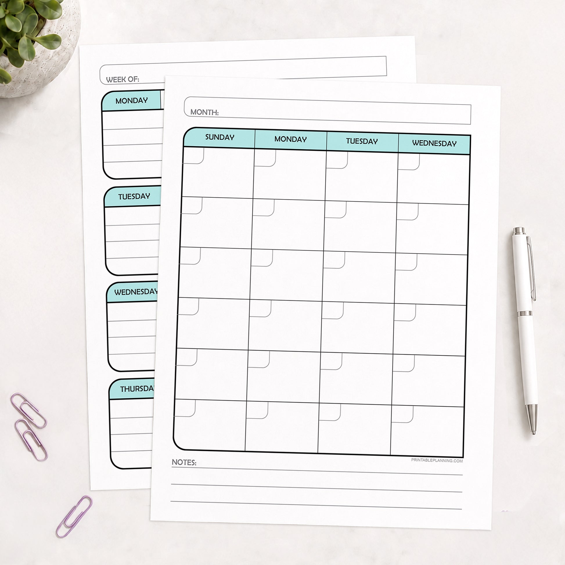 The printed Teal Undated Monthly & Weekly Planner (printable) Pages shown on a desk with a plant, paperclips, and a pen.