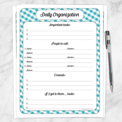 The printable Turquoise Gingham Daily Planner for Priorities, Calls, Errands & To-Dos page shown on a marble surface with a pen.