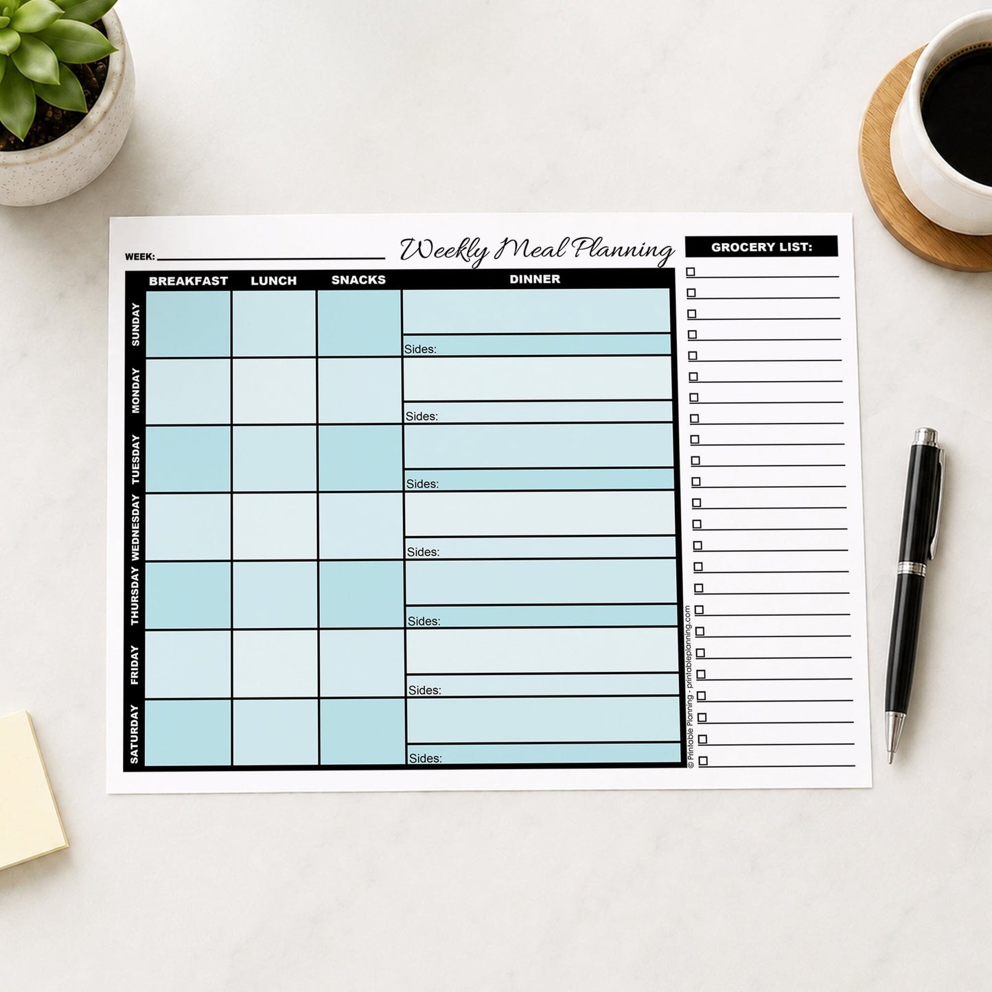 A printed Turquoise Weekly Meal Planner with Grocery List (printable page) shown on a table with a plant, sticky notes, coffee, and a pen.
