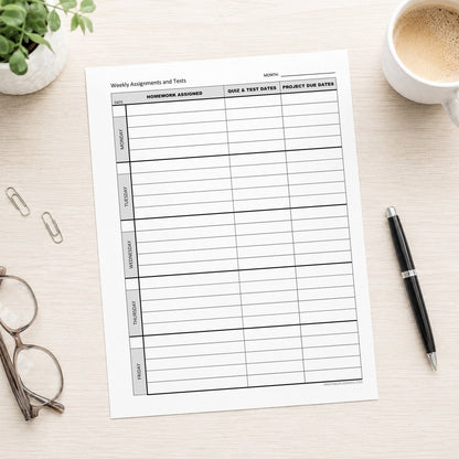 A printed Weekly Student Assignment Tracker for Homework, Tests & Projects (printable page) shown on a table with a plant, glasses, coffee, paperclips, and a pen.