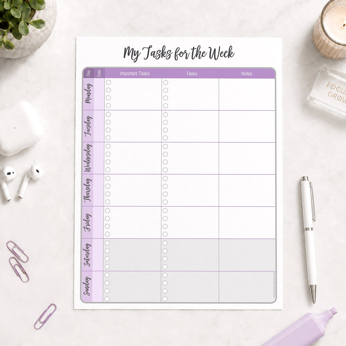 The printed Purple Weekly Task Planner with Priorities, Checklists & Notes (printable) page shown on a desk with a plant, earbuds, paperclips, highlighter, and a pen.