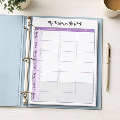 The printed Purple Weekly Task Planner with Priorities, Checklists & Notes (printable) page shown in light blue binder on a desk with a plant, coffee, and a pen.