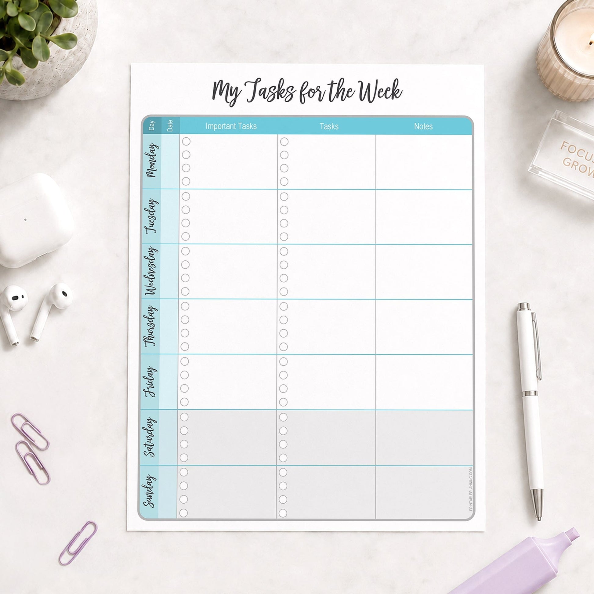 The printed Turquoise Weekly Task Planner with Priorities, Checklists & Notes (printable) page shown on a desk with a plant, earbuds, paperclips, highlighter, and a pen.