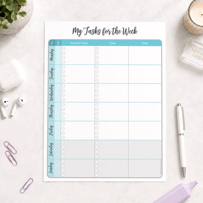 The printed Turquoise Weekly Task Planner with Priorities, Checklists & Notes (printable) page shown on a desk with a plant, earbuds, paperclips, highlighter, and a pen.