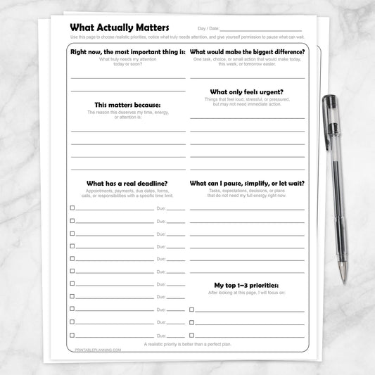 What Actually Matters Priority Worksheet shown on a marble surface with a pen.