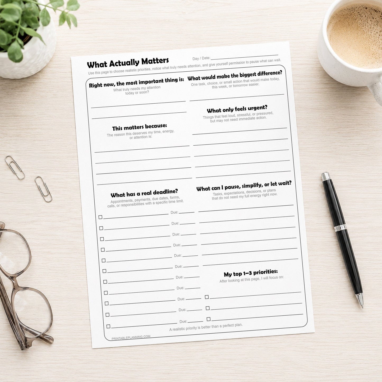 What Actually Matters Priority Worksheet shown on a desk with a pen, glasses, plant, and coffee.