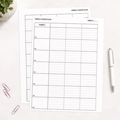 Two White Weekly Lesson Plan Pages for Teachers - Printable PDF sheets with black printed grid lines, arranged on a light surface with a white pen, purple paperclips, and a small plant in the corners.