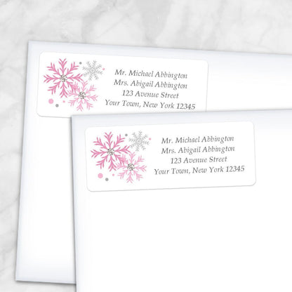Printable Winter Pink Gray Snowflake Address Labels at Printable Planning. Shown on envelopes.