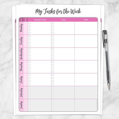 The printable Pink Weekly Task Planner with Priorities, Checklists & Notes page shown on a marble surface with a pen.