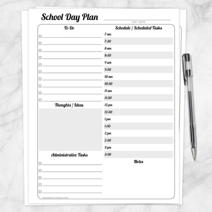 A printable School Staff Daily Planner with Schedule and To-Do List shown on a marble surface with a pen.