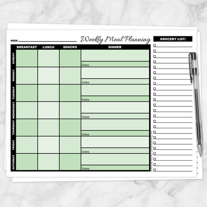 A printable Green Weekly Meal Planner with Grocery List shown on a marble surface with a pen.