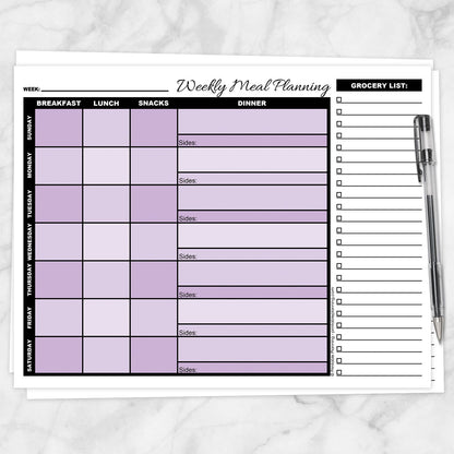A printable Purple Weekly Meal Planner with Grocery List shown on a marble surface with a pen.