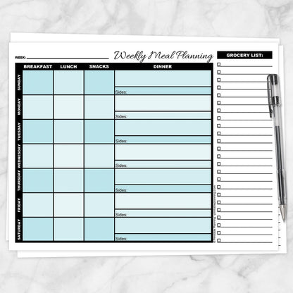 A printable Turquoise Weekly Meal Planner with Grocery List shown on a marble surface with a pen.
